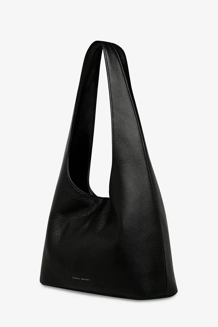 Black shoulder bag on a light gray background
