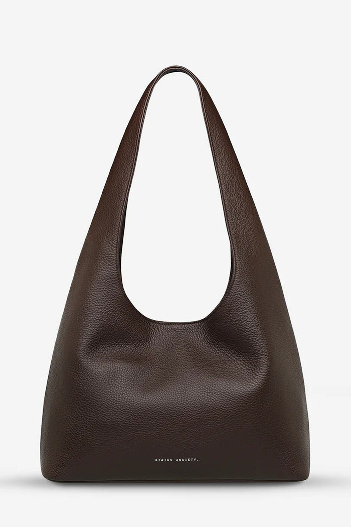 Brown leather shoulder bag on a light gray background