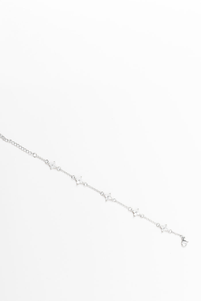 Silver bracelet with small stones on a white background