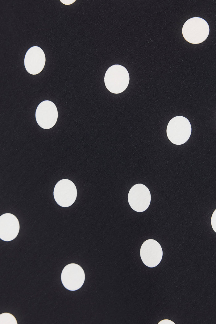 Black fabric with white polka dots