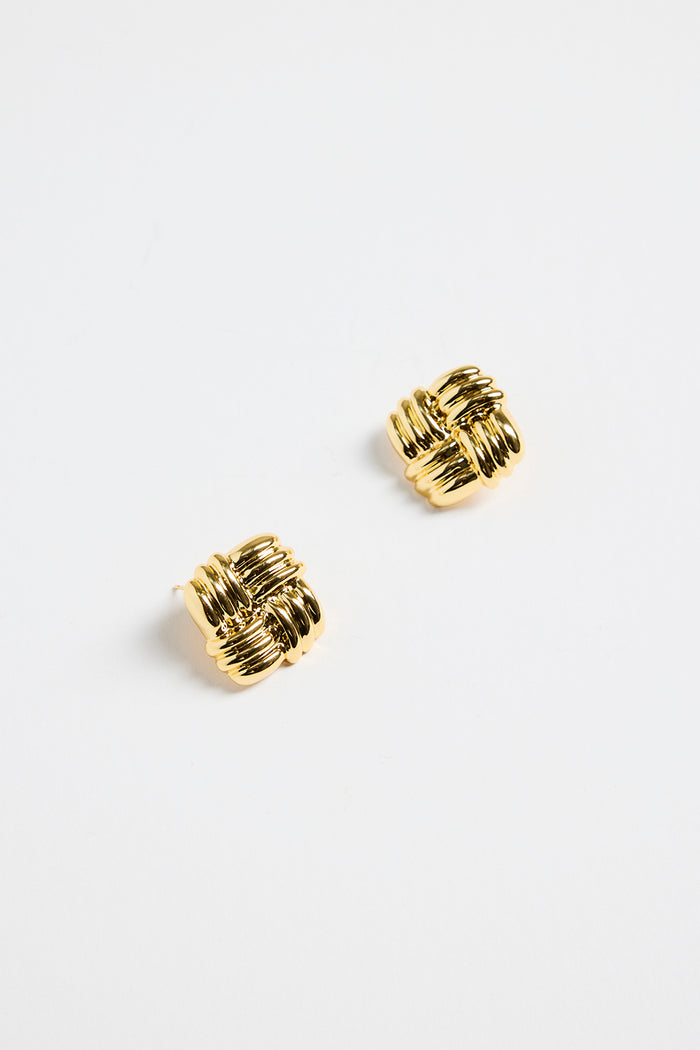 gold-plated brass stud earrings with an interwoven square design, photographed flat on a white background.