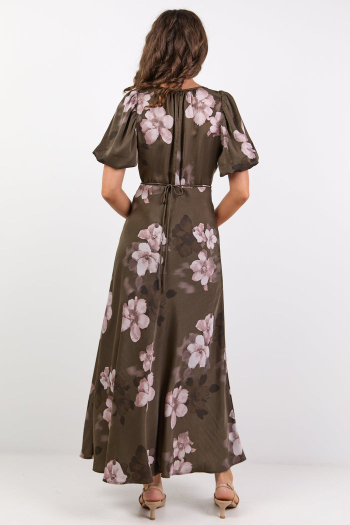 Woman wearing a floral dress with a white background
