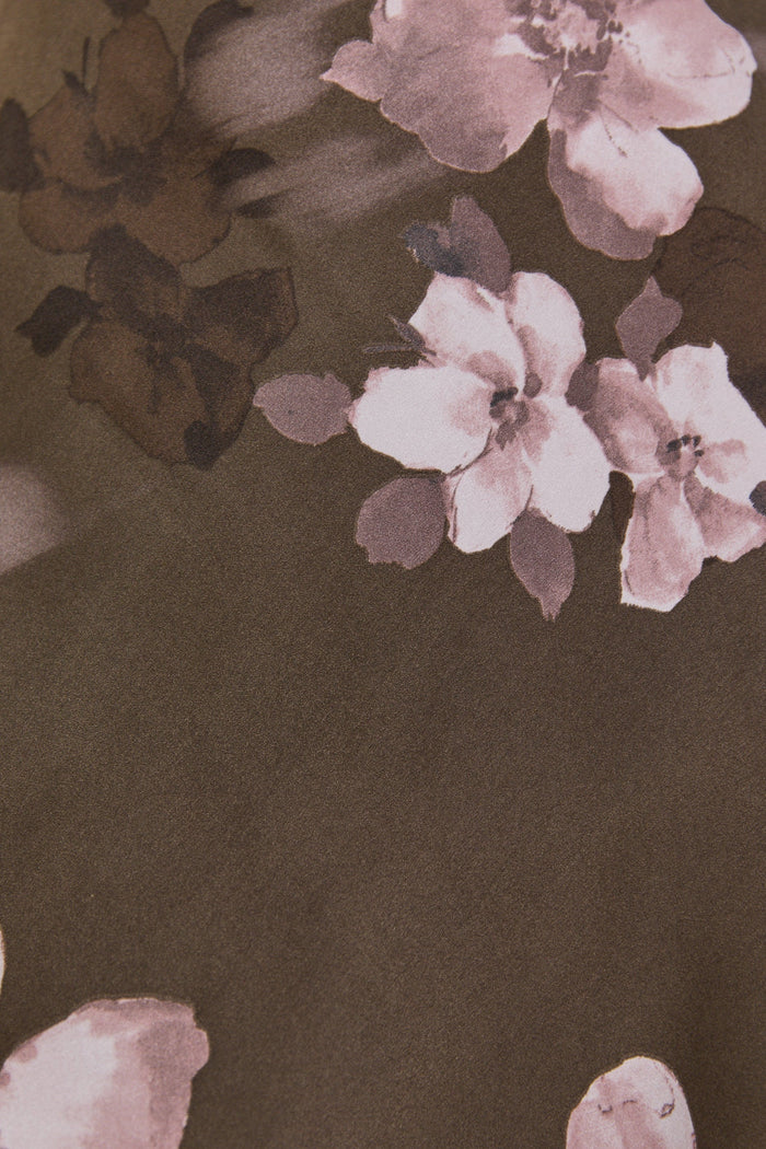 Floral pattern on a brown fabric background