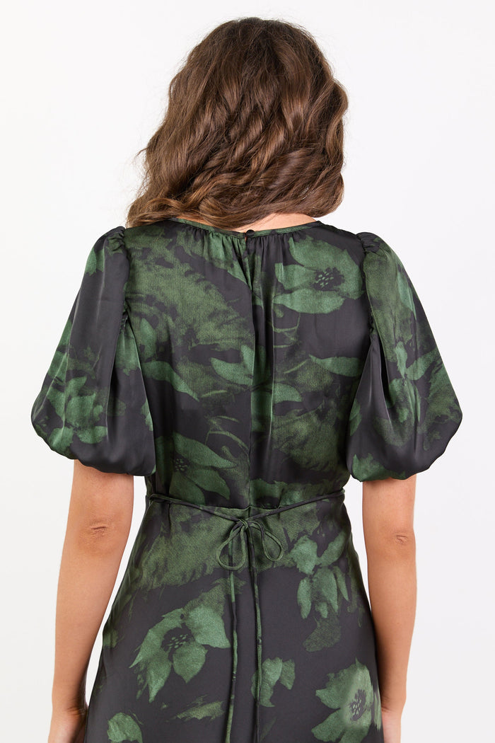Green and black floral patterned dress on a white background