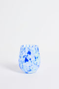 Blue and white speckled glass vase on a light gray background