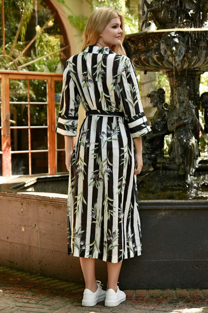 Woman wearing a black white stripe with olive branches