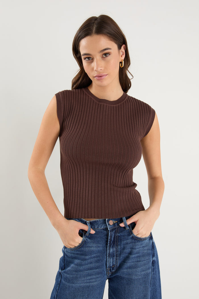 model wears a brown rib knit with blue jeans