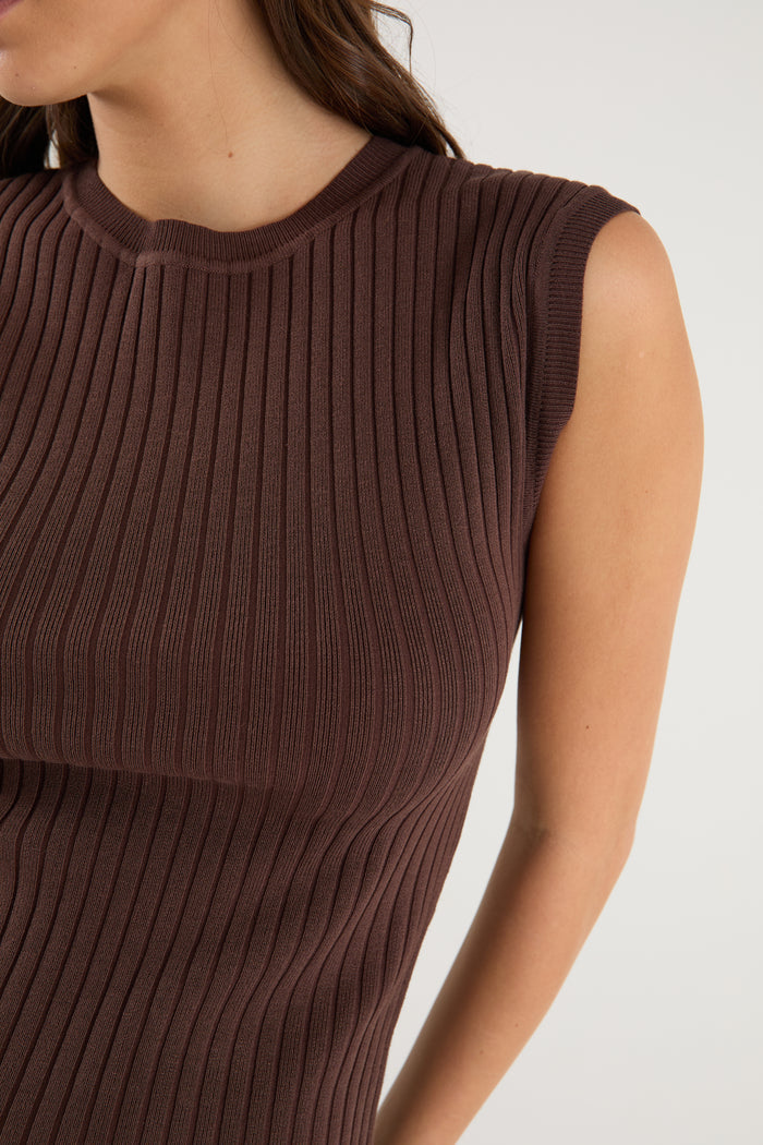 model wears a brown rib knit with blue jeans
