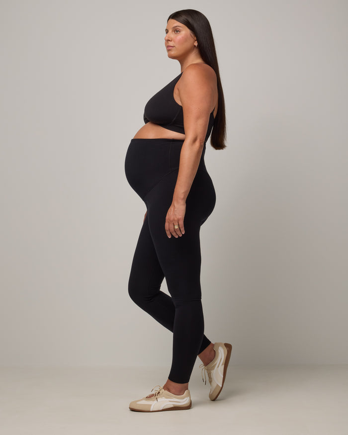 Model wearing Summit Maternity Leggings in Black. Summit Maternity Leggings are merino wool, full length leggings available in sizes XS-3X.