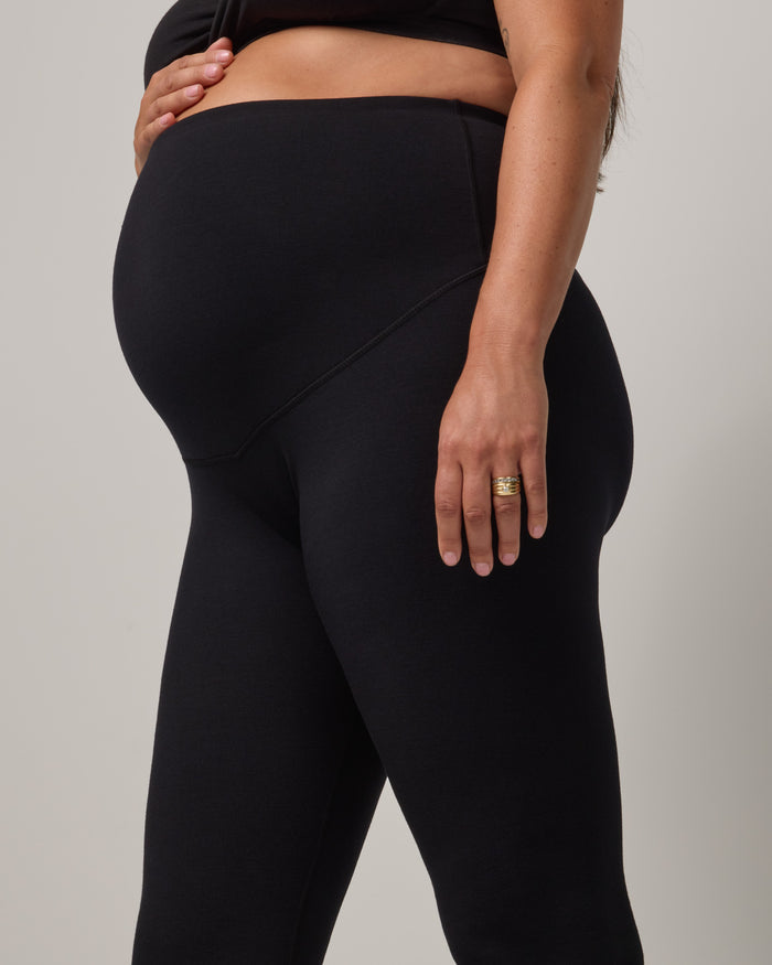 Model wearing Summit Maternity Leggings in Black. Summit Maternity Leggings are merino wool, full length leggings available in sizes XS-3X.