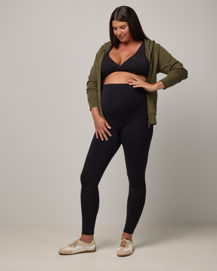 Model wearing Summit Maternity Leggings in Black. Summit Maternity Leggings are merino wool, full length leggings available in sizes XS-3X.