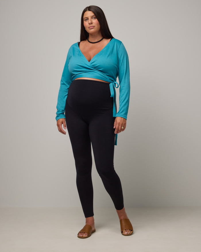 Model wearing Summit Maternity Leggings in Black. Summit Maternity Leggings are merino wool, full length leggings available in sizes XS-3X.