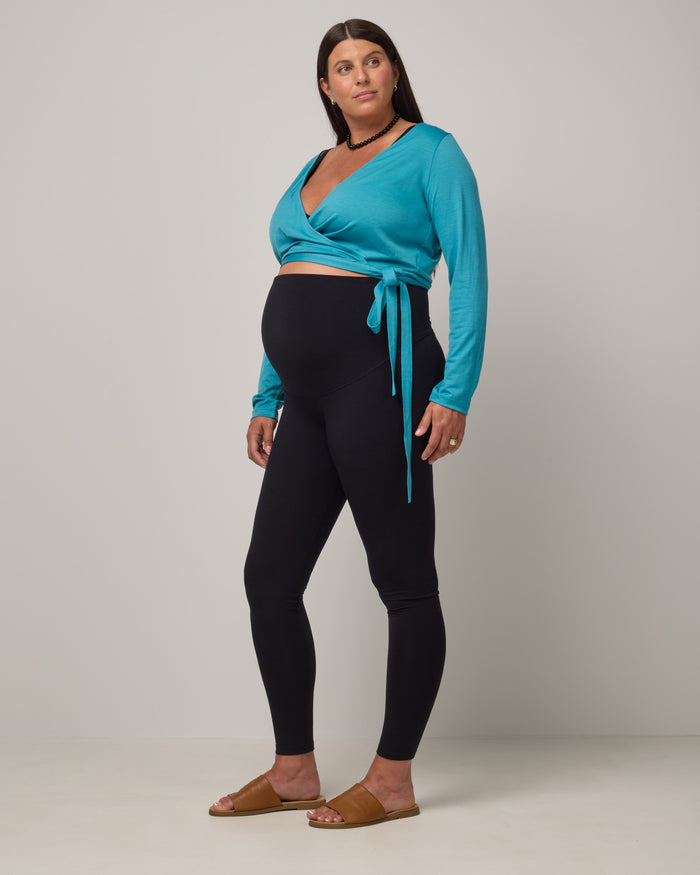 Model wearing Summit Maternity Leggings in Black. Summit Maternity Leggings are merino wool, full length leggings available in sizes XS-3X.