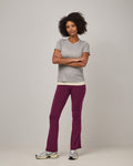 Model wearing Summit Straight Cut Pocket Legging in Plum, a purplish-red color. Summit Straight Cut Pocket Legging is a merino wool legging with pockets available in sizes XS-3X Regular, S-XXL Long.