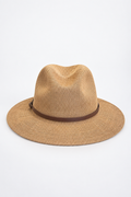 A woven straw fedora hat in a light tan color with a dark brown band, photographed from the side against a plain white background.