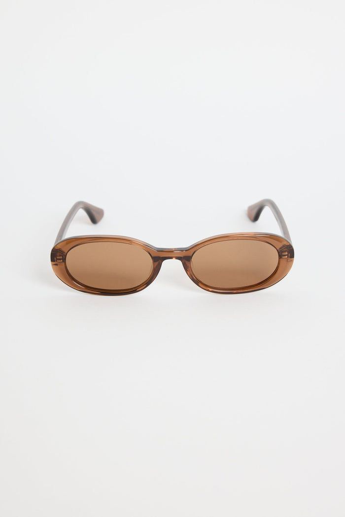 Sunglasses with brown lenses and thin metal frames on a white background