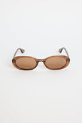 Sunglasses with brown lenses and thin metal frames on a white background