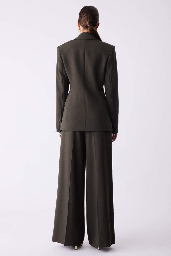 Person wearing a dark gray suit on a white background