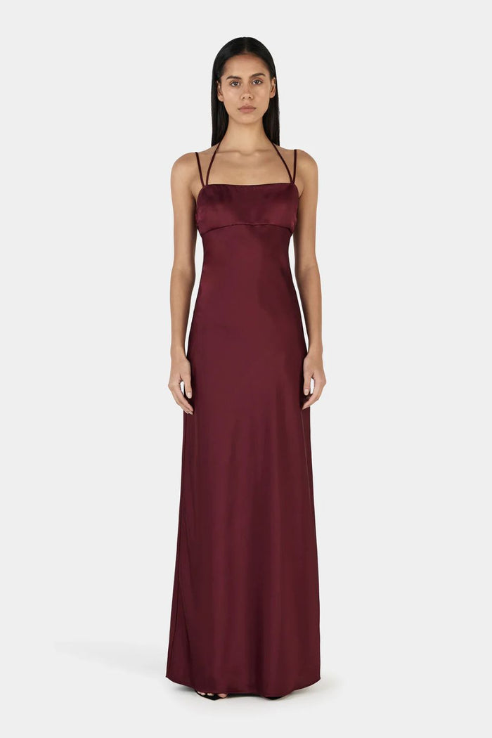 Model wears a burgundy event dress
