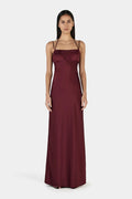 Model wears a burgundy event dress