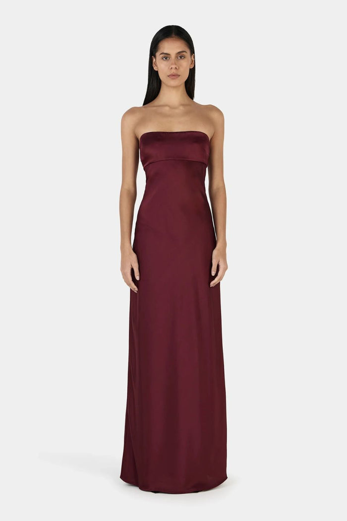 Model wears a burgundy event dress