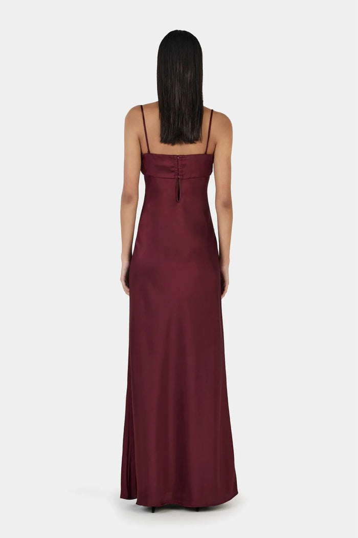 Model wears a burgundy event dress
