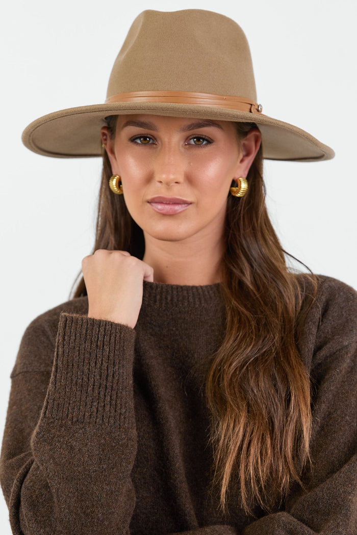 Woman wearing taupe beige wool hat.
