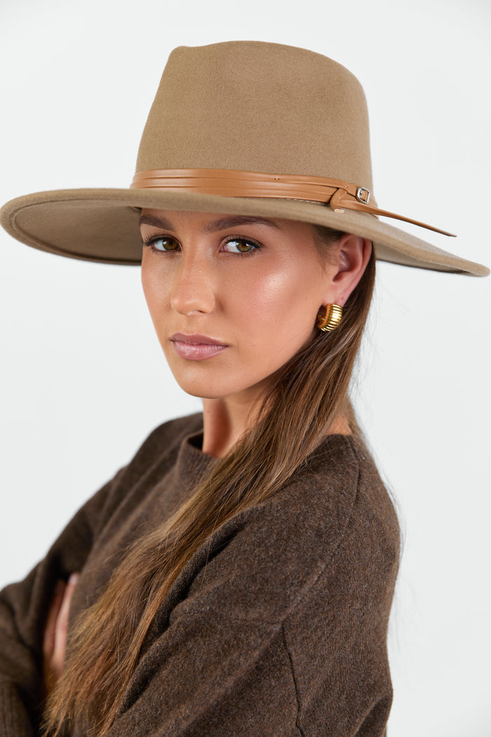 Woman wearing taupe beige wool hat.