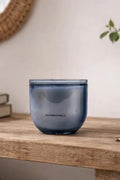 Blue glass container on a wooden surface with a blurred background