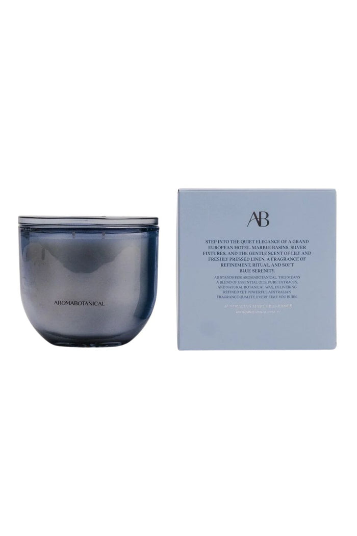 A blue glass jar candle next to its light blue packaging box, featuring the AB Clean Fragrances logo and product details, set against a plain white background.