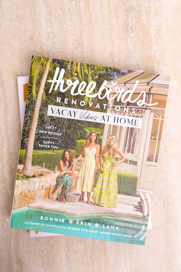 Book titled 'How to Renovate Your Vacay Home' on a wooden surface