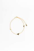 Gold bracelet with heart-shaped charms on a white background