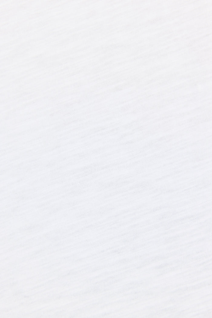 A close-up of a white textured fabric with subtle diagonal ribbing.