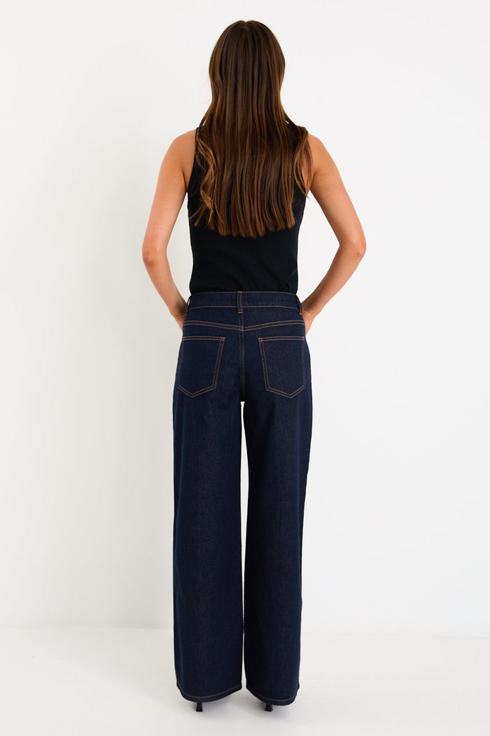 Woman wearing dark denim jean and black singlet