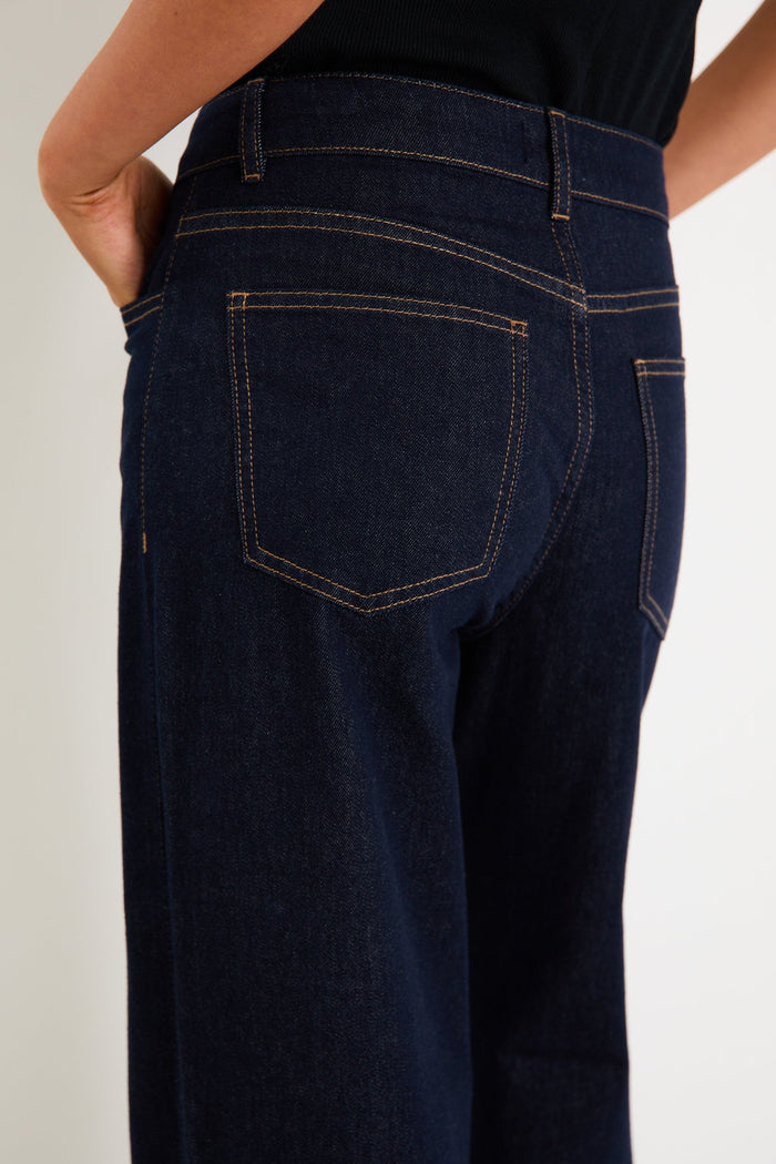 Woman wearing dark denim jean and black singlet
