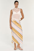 Woman wearing a light pink sleeveless top and striped skirt on a white background