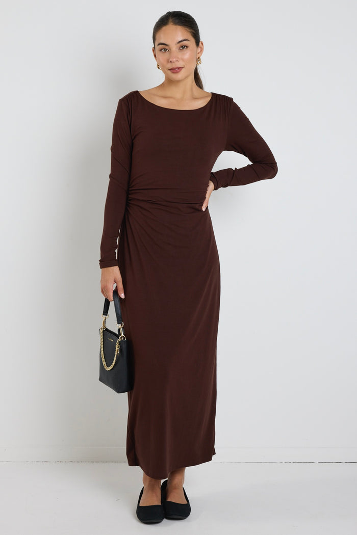 model wears a black long sleeve maxi dress