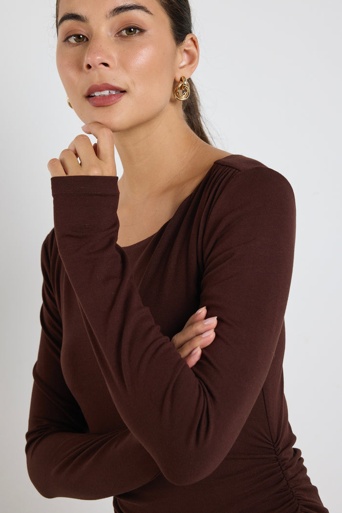 model wears a black long sleeve maxi dress