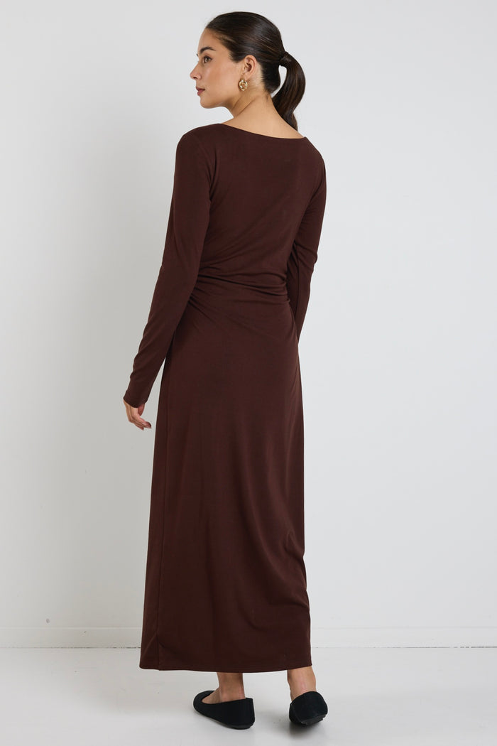 model wears a black long sleeve maxi dress