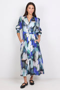 Woman wearing a long, blue patterned dress on a white background
