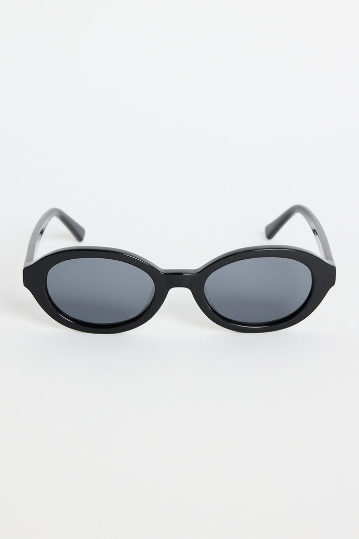Black oval sunglasses with dark tinted lenses and a glossy frame, photographed against a white background