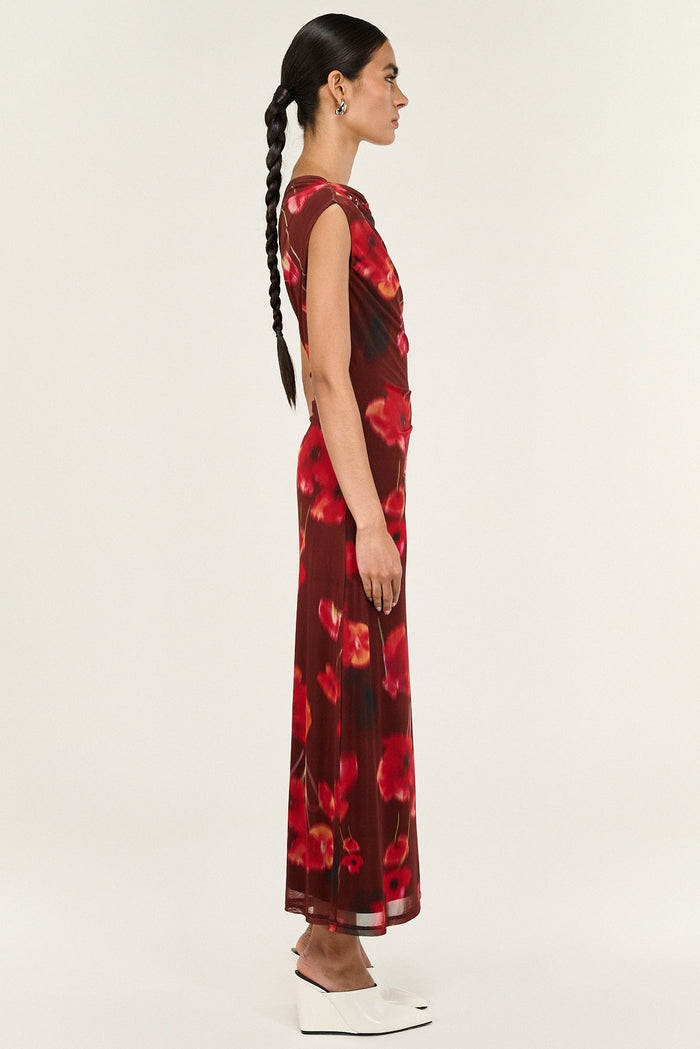 Woman wearing a red floral dress on a white background