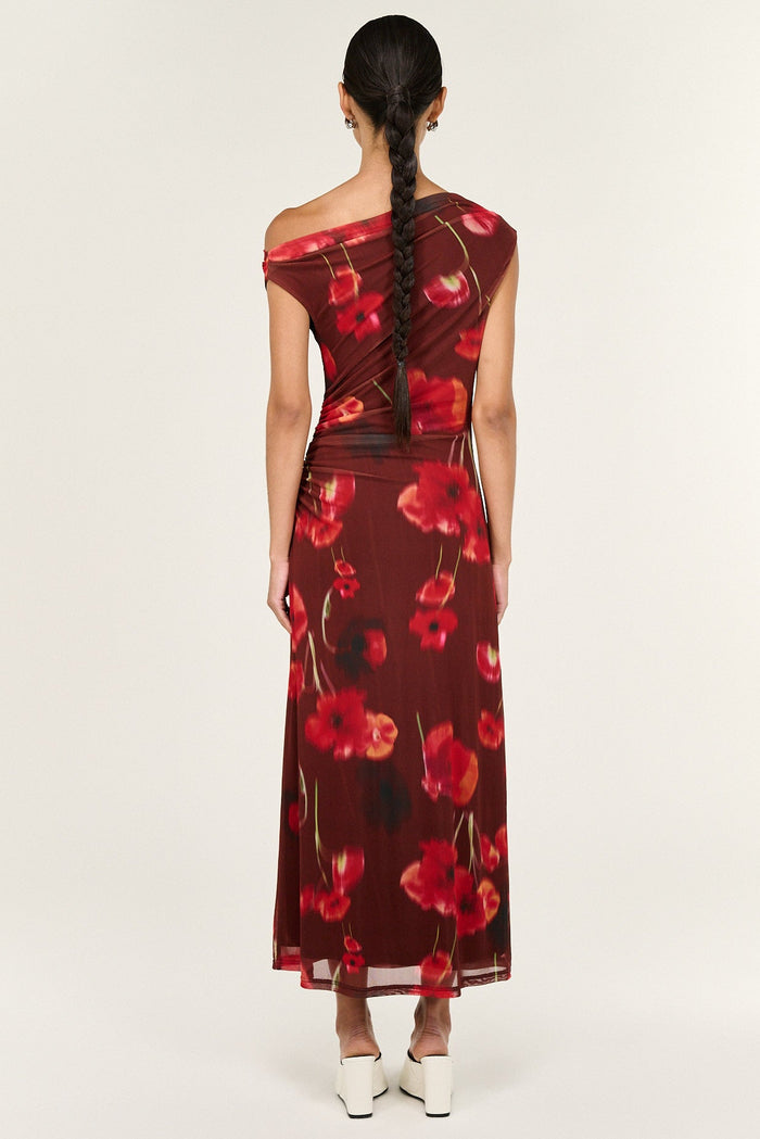 Woman wearing a red floral dress on a white background