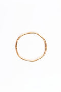Gold bangle on a white background