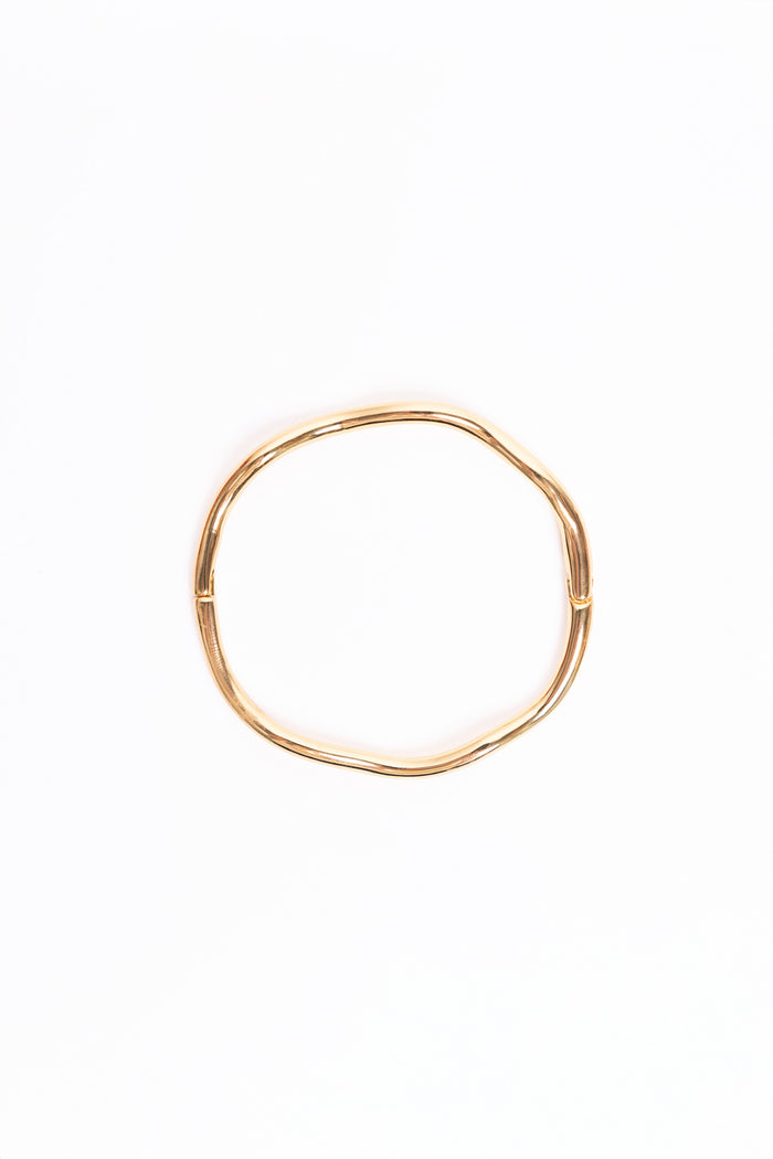 Gold bangle on a white background