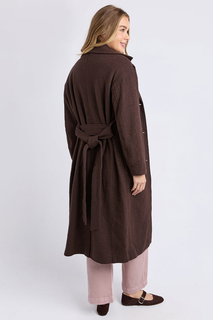 Woman wearing a brown coat on a white background