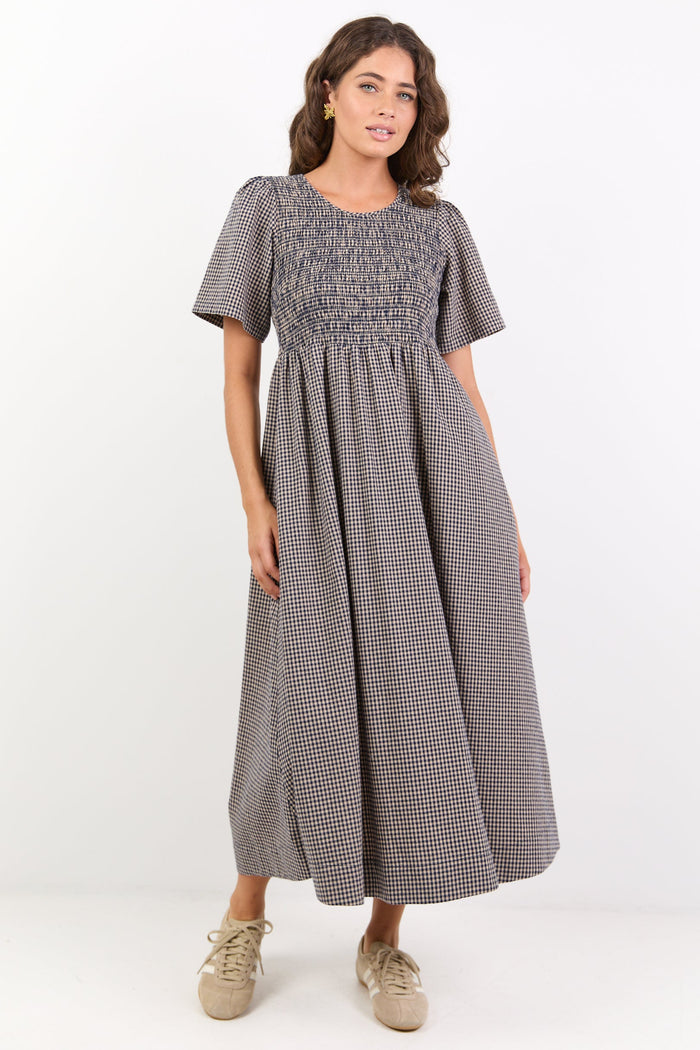 Woman wearing a checkered dress on a white background