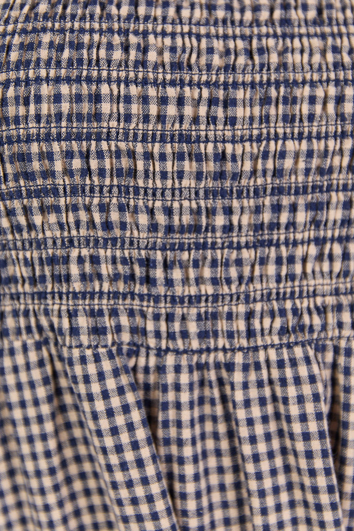 Close-up of a blue and white checkered fabric with a gathered waistband.