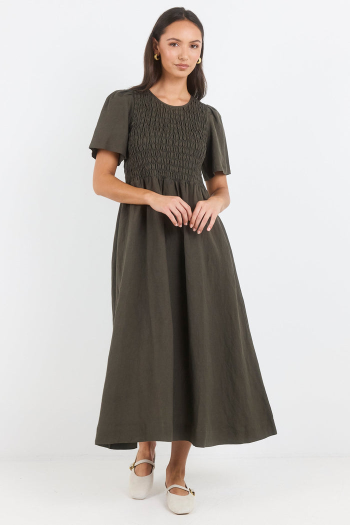 Woman wearing a green dress on a white background
