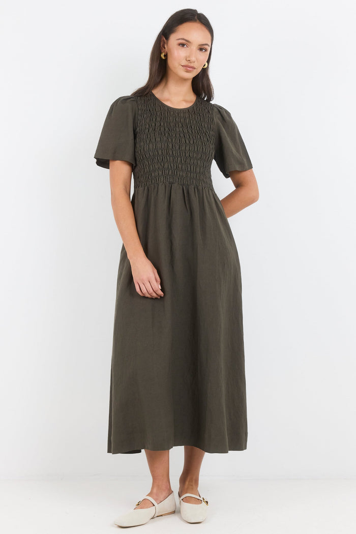Woman wearing a green dress on a white background